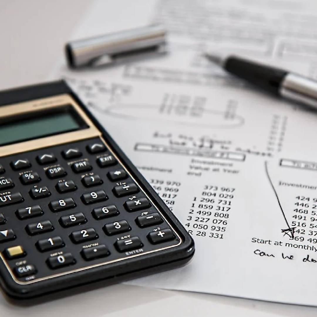 A calculator sitting on top of some papers