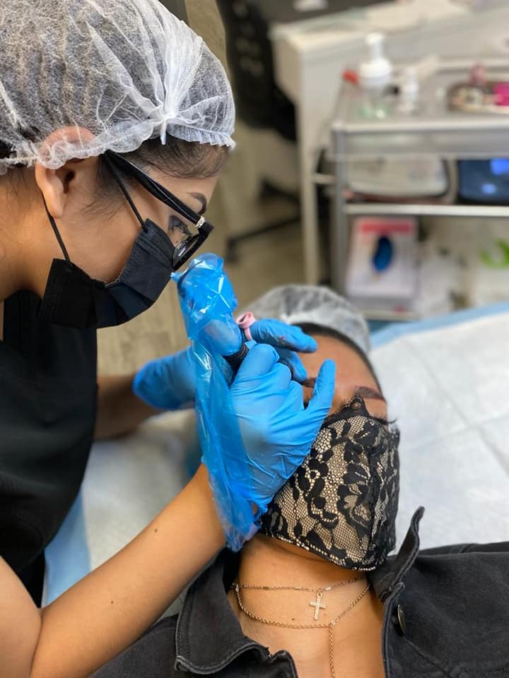 A person getting their nails done by someone else