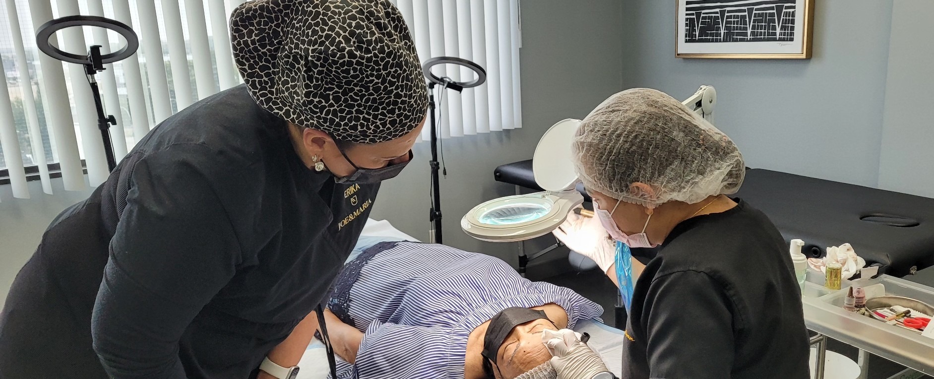 A woman is getting her face cleaned by two other women.