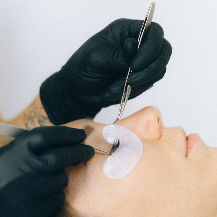 A person getting their face shaped with scissors