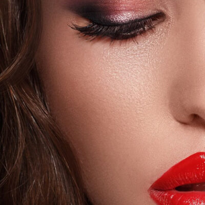 A close up of a woman 's face with red lipstick