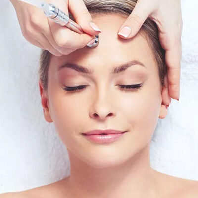 A woman getting her face waxed at the spa