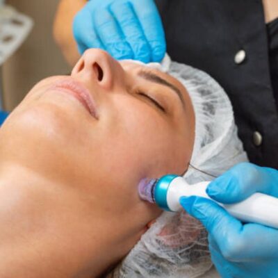 A woman getting her face waxed at the spa