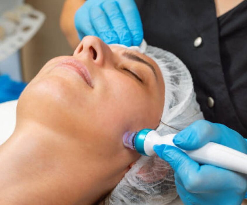 A woman getting her face waxed at the spa